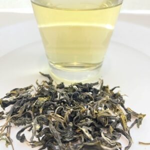 Brewed Organic Blossom Green Tea and its dry leaves